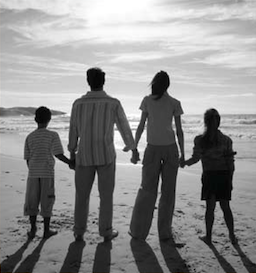 Family holding hands at the beach