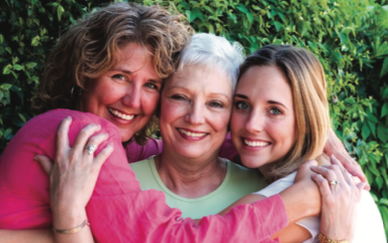 Three generations smiling and hugging