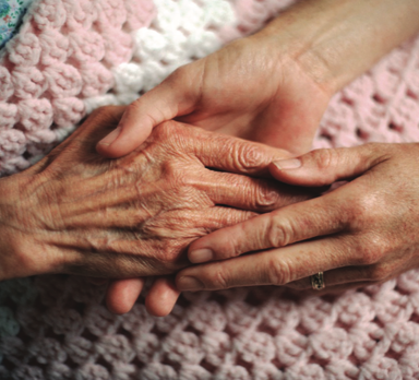 Grandparent and adult child holding hands